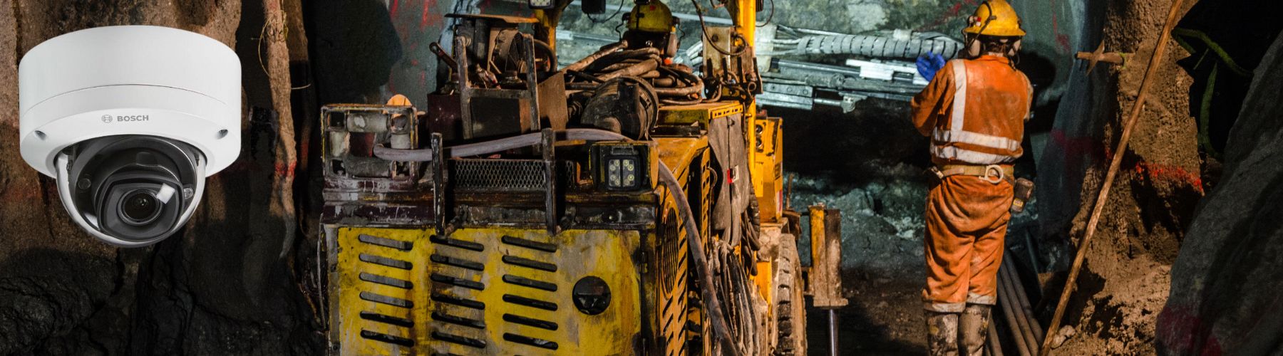 CCTV camera on a construction site with workers and heavy machinery.