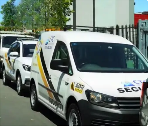 White CTC Security van and SUV with yellow and black branding parked in a line.